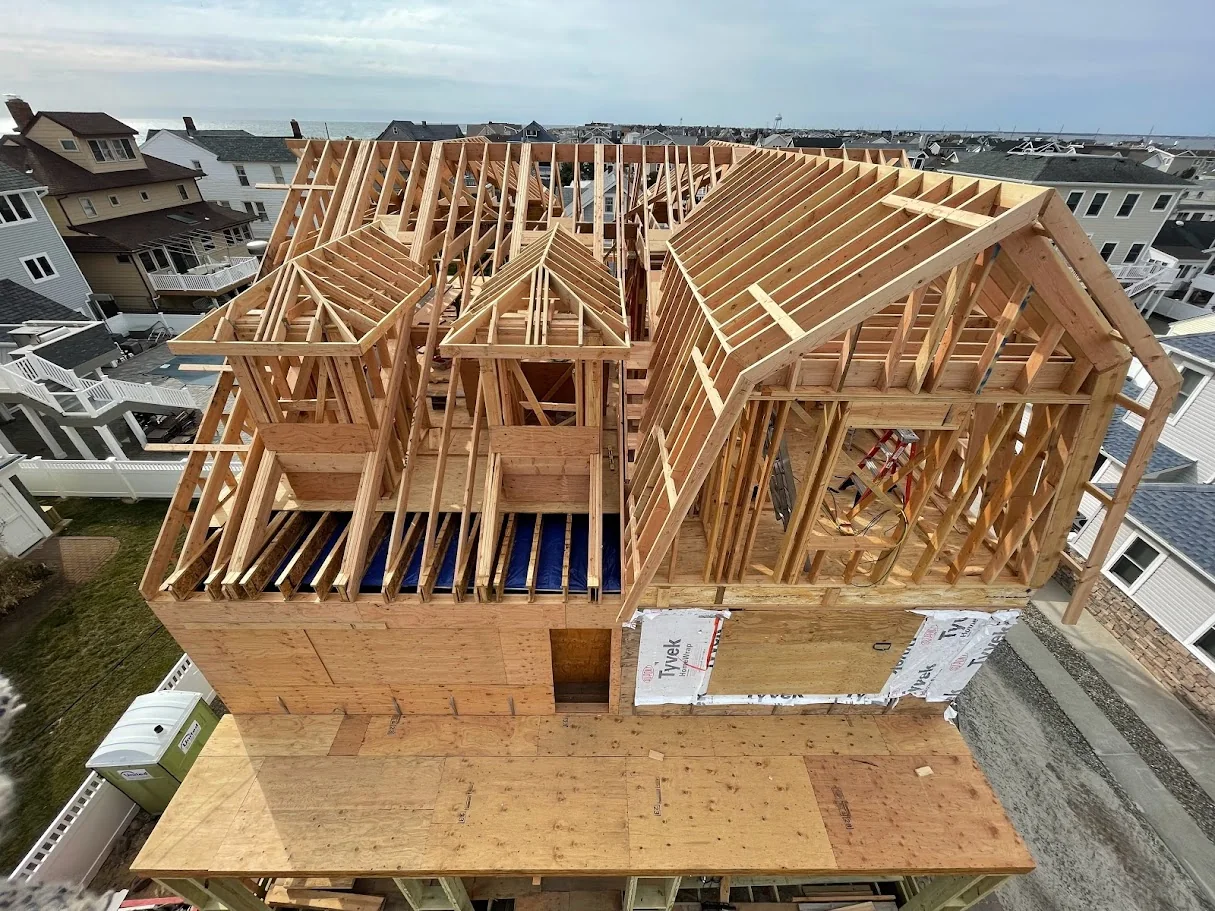 Aerial view of complex roof framing on a shore build