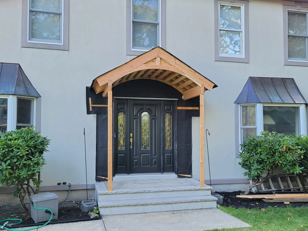 Custom arched front entry portico framing before finish