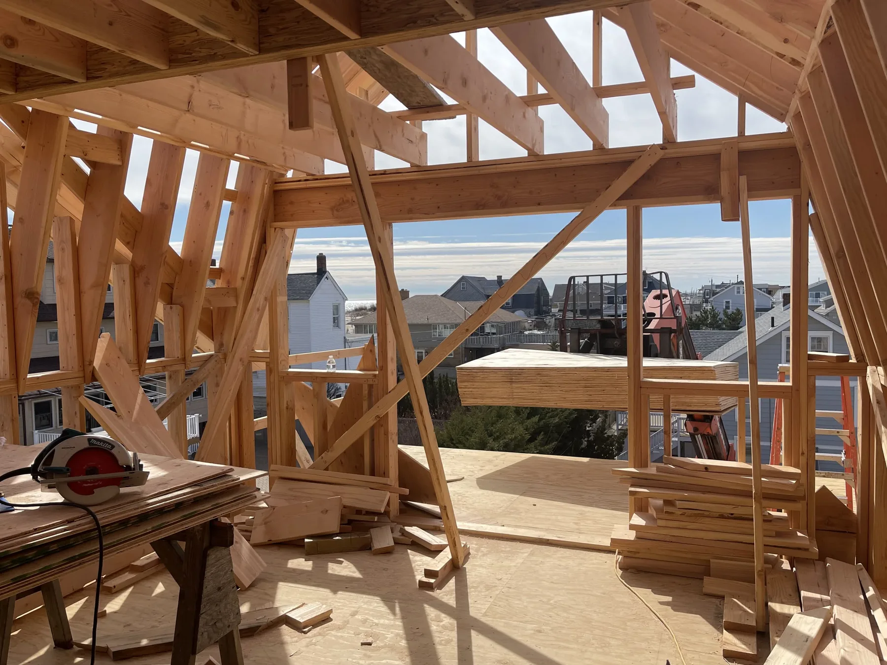 Interior view through dense roof and wall framing
