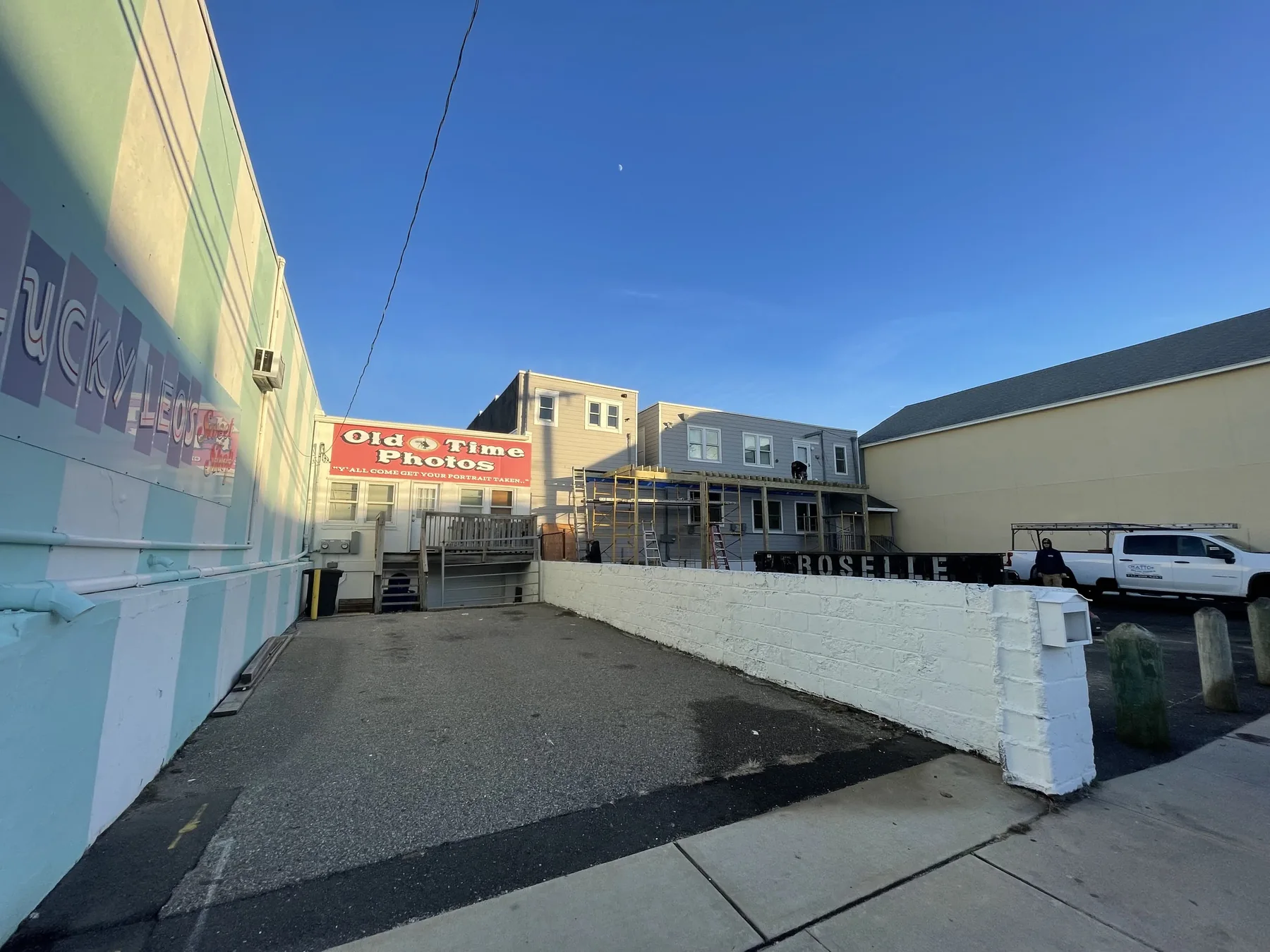 Motel deck rebuild jobsite with staging and neighboring buildings