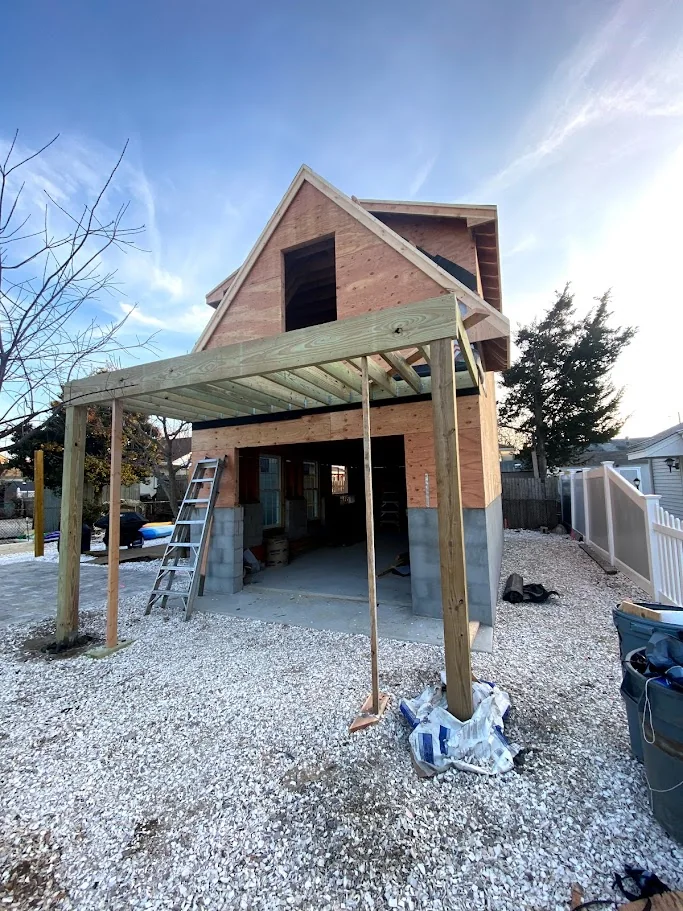 Rear gable porch and covered patio framing under construction