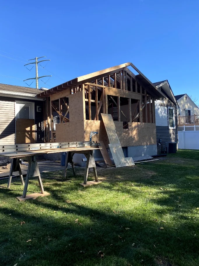 Side addition framed and sheathed in afternoon light