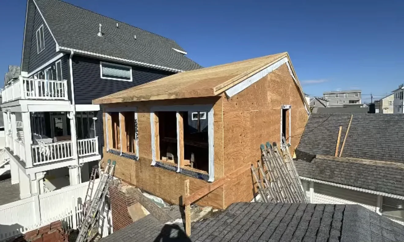 Second-story addition framed and sheathed over a former flat roof on a coastal home