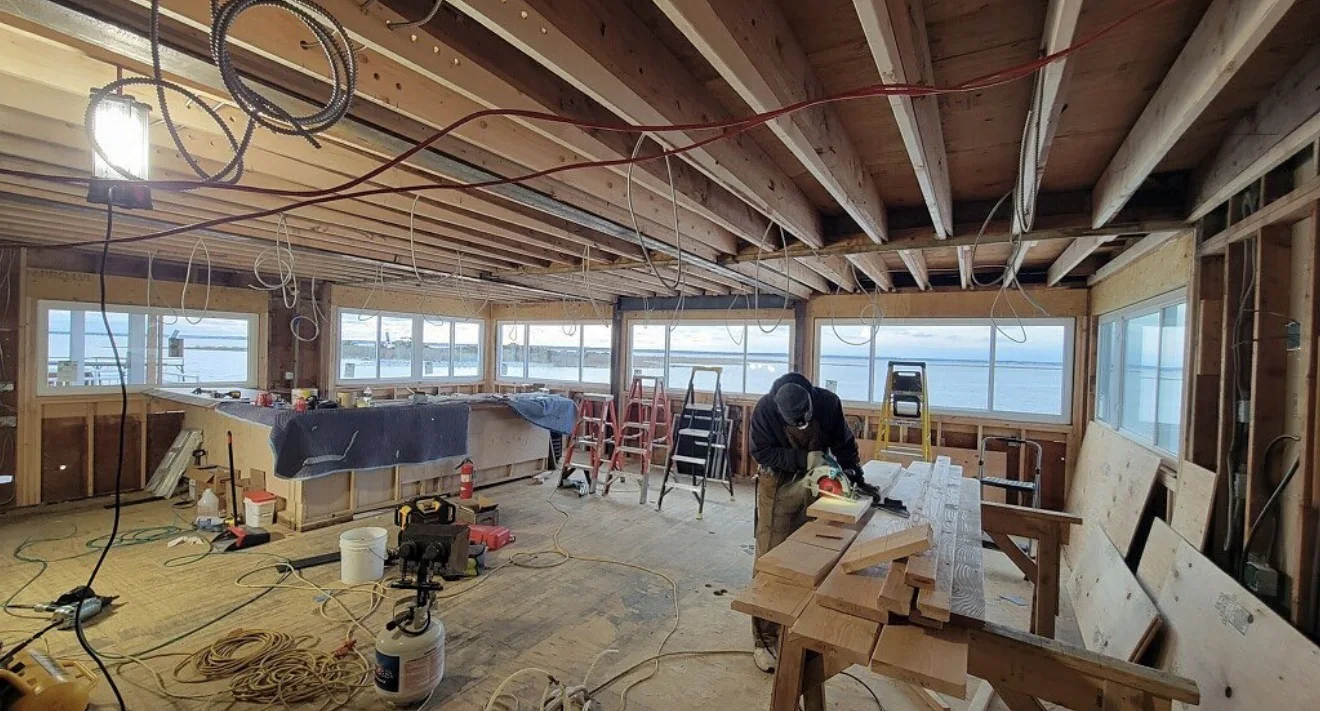 Interior framing and finish carpentry at the Lavallette Yacht Club with ocean-view window openings